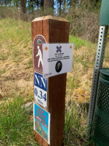 Scavenger hunt point on trail post.